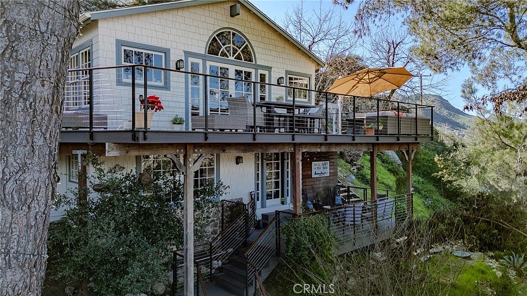 Exterior view of the multi-level cottage among trees